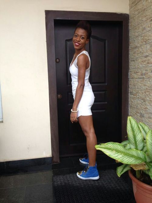 Ezinne Chinkata Wearing a White Dress and Shoes
