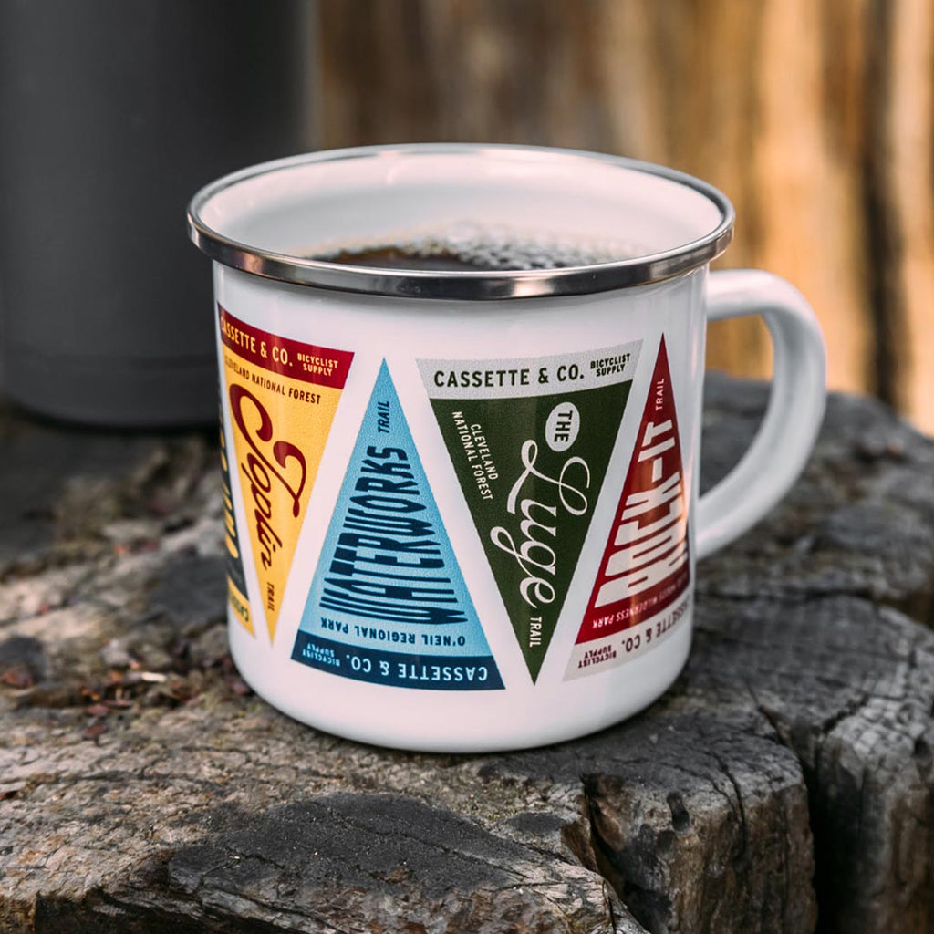 singletrack searchers trail pennant camp mug on a log with coffee in it