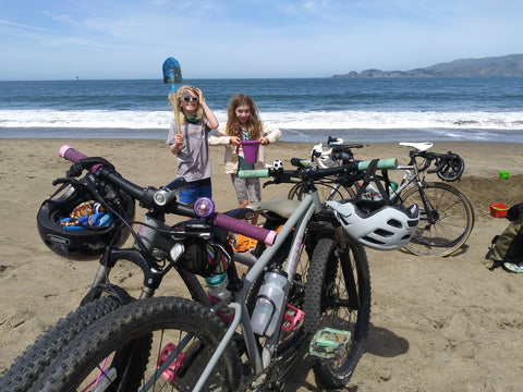 Lynell's twins at the beach with their bikes.
