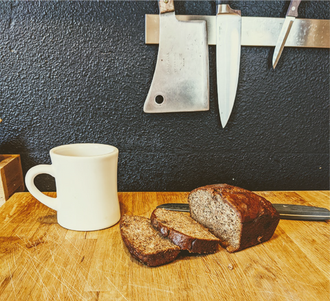 Photo of warm, sliced banana break resting on a cutting board.