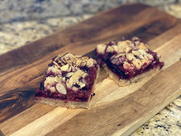 Mixed berry bars on a wooden cutting board.