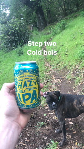 Austin holding a beer and his dog.