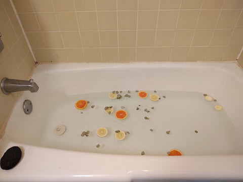 Bath tub full of water and slices of citrus