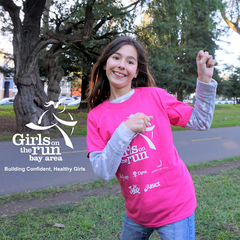 Girl wearing a "Girls on the Run" shirt.