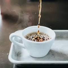 Pouring a cup of coffee.