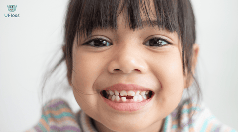 Young girl showing her missing baby teeth
