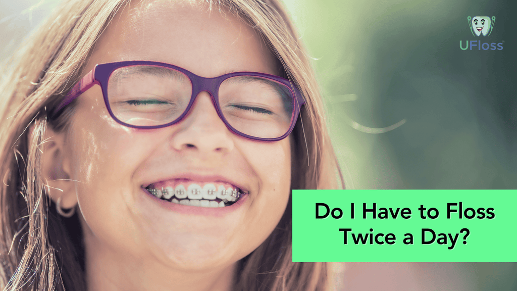 Young girl with purple glasses showing a wide grinned smile showing braces and a healthy mouth