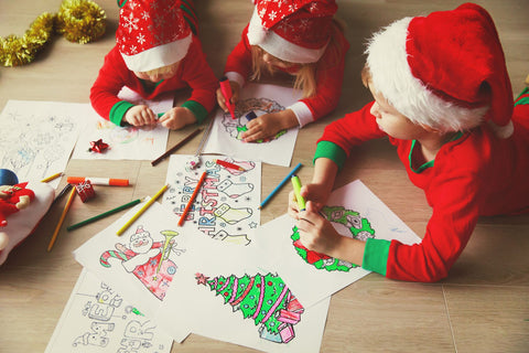 Kids drawing on Christmas paper