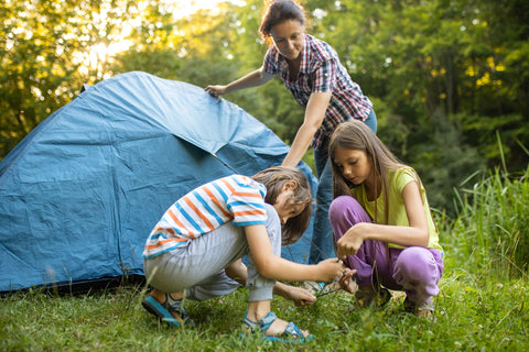 Family setting up their tent in Australia