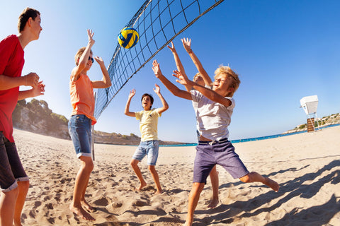 A family playing beach volleyball in Australia