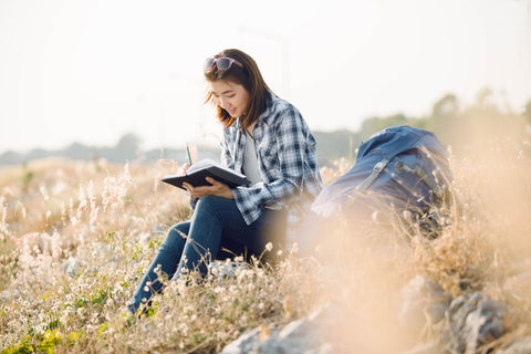 A woman writing into her travel journal