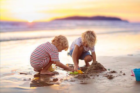 Kids building a sand castle on the beach in Australia