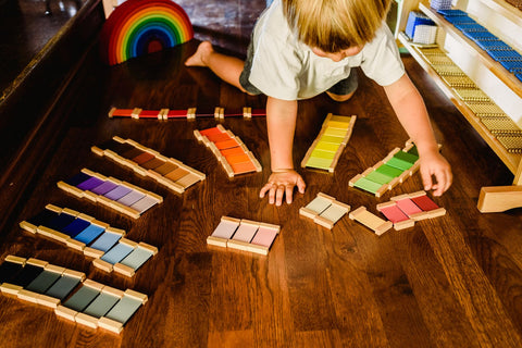 Young child playing with wooden Montessori toy