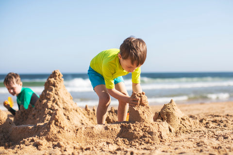 boy building a sand castle on an Australian beach