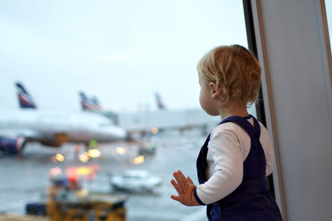 Baby watching planes at the airport