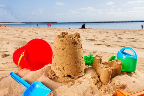 Sandcastle with moulds and shovels