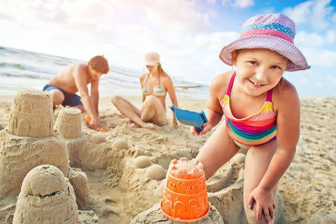 Family building a sand castle in Australia