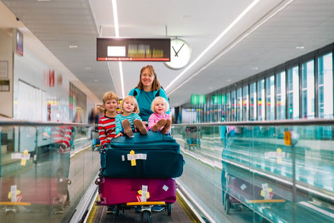 Mother with small children and luggage at the airport