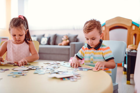 Small children completing a puzzle 
