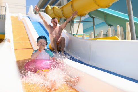 Father and son on a waterslide on their family holiday