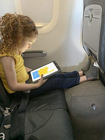Child using an inflatable footrest on the plane