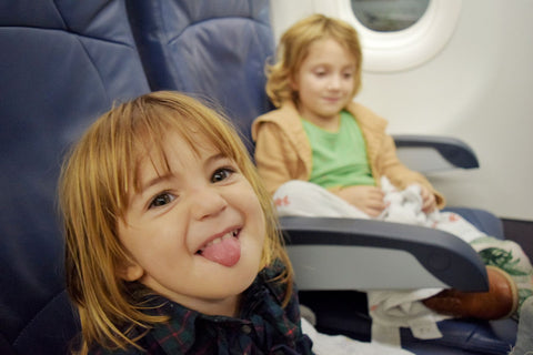 Two toddler sitting together on an aeroplane