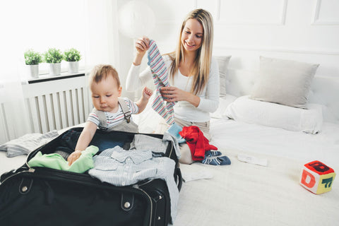 Mother and baby packing a suitcase