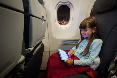 Girl with tablet on aeroplane