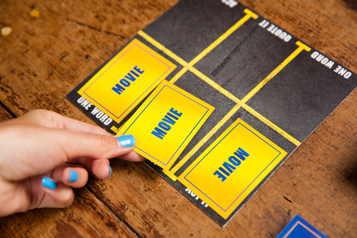 A hand taking a movie card off the Blockbuster Returns board