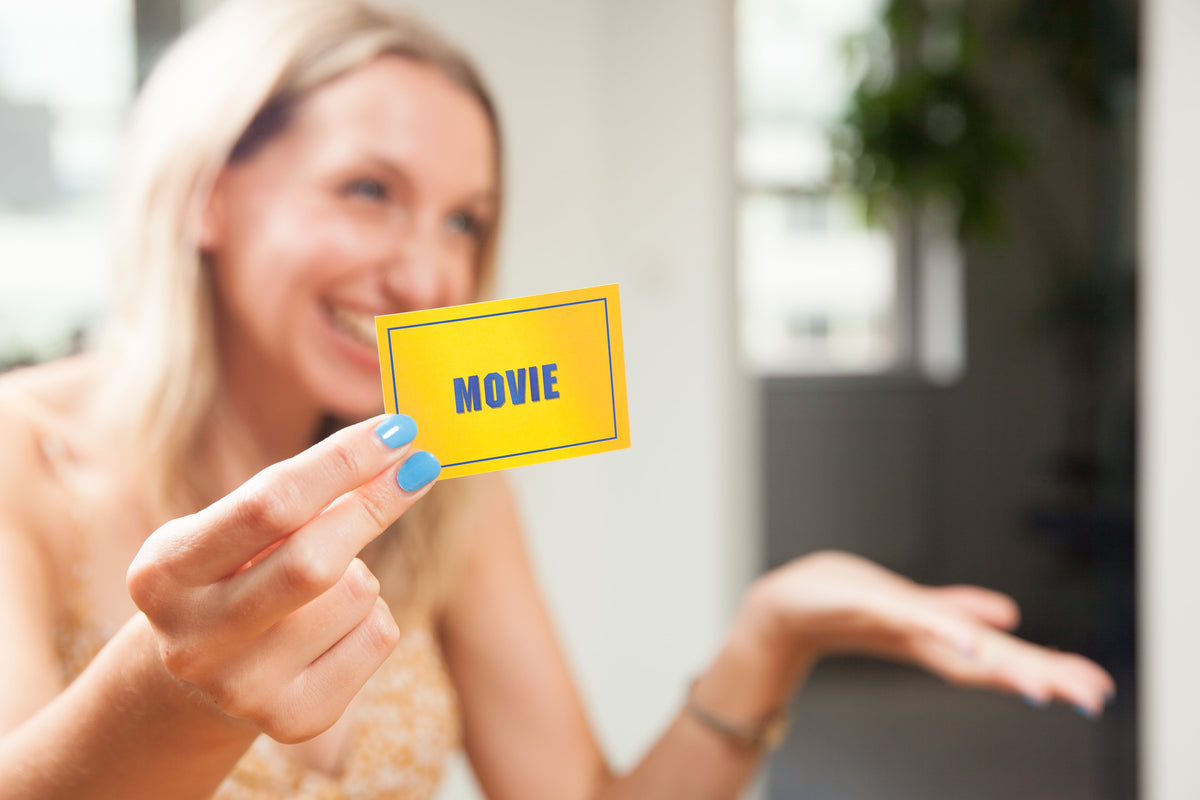Woman holding Movie card