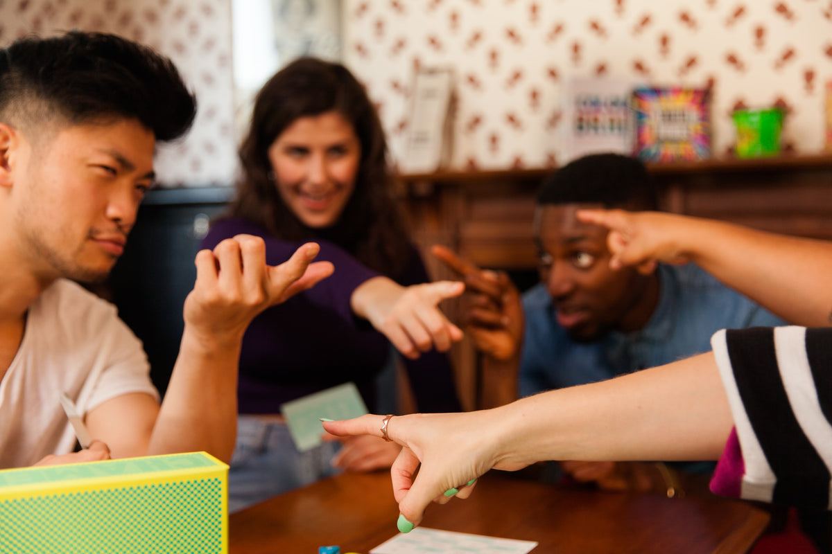 Group of people pointing at each other