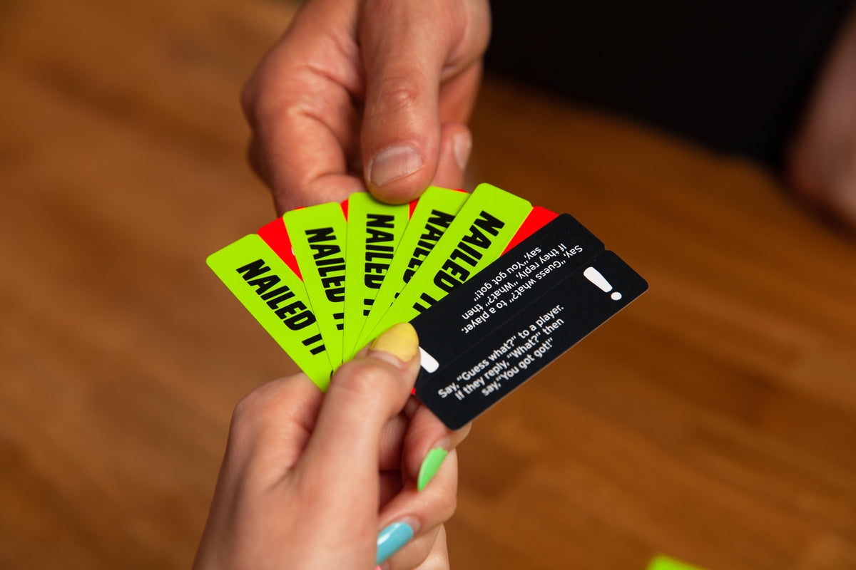 A hand taking a mission card