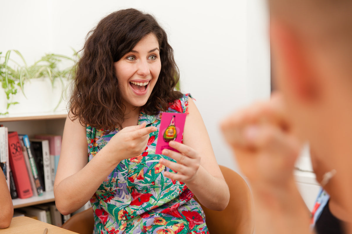 Woman holding Mr. Lister's Quiz Shootout card 