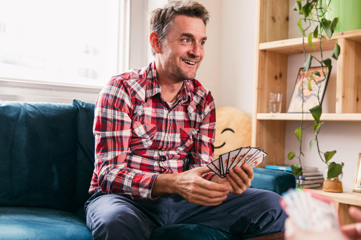 Man smiling, holding Muffin Time cards