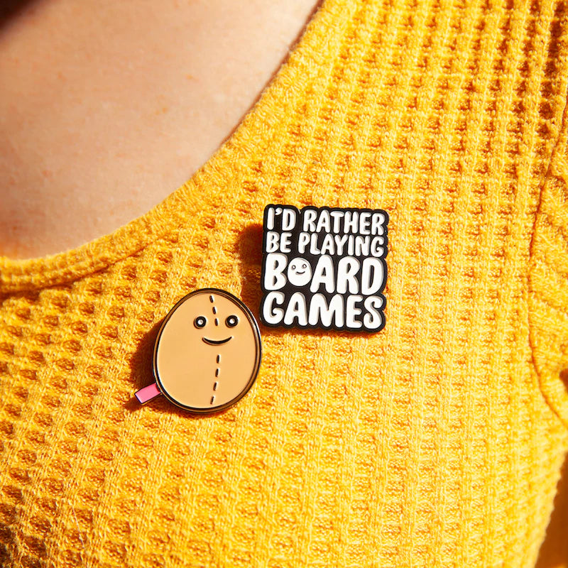 Enamel pin on yellow shirt