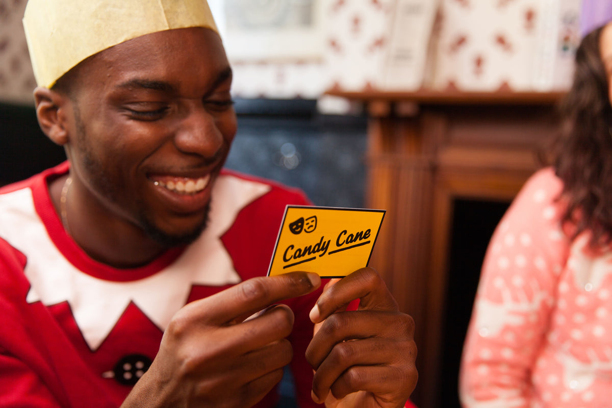 Man laughing holding 'Candy Cane' card