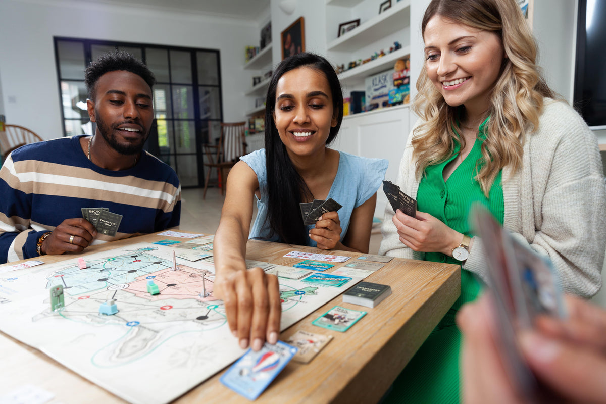 Three people playing The Great American Mail Race