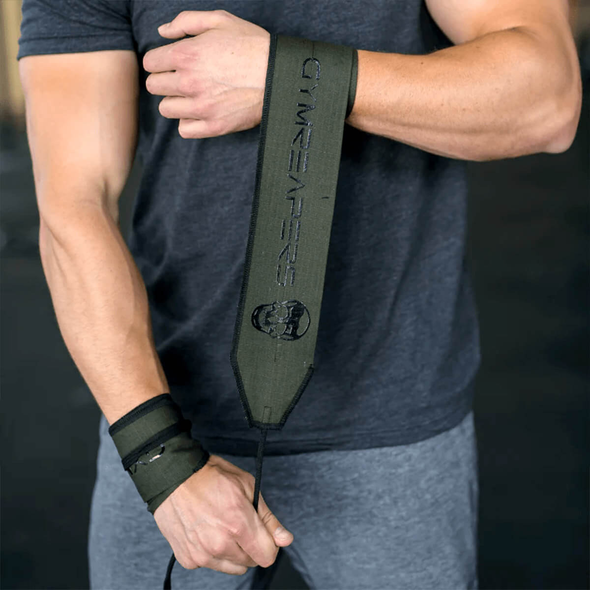 Close-up image of an athlete wrapping Gymreapers CrossFit wrist wraps, highlighting secure and durable design for optimal wrist support during high-intensity workouts. Ideal for athletes seeking the best wrist wraps for CrossFit, weightlifting, and performance stability.
