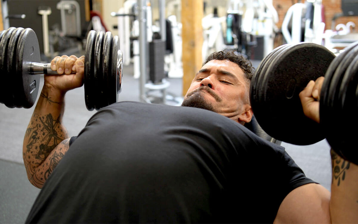 Gymreapers athlete, Jack West, executing a dumbbell incline press to build upper chest strength with optimal form.