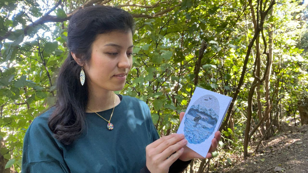 Emy holding the Ocean's Symphony Plantable and Reusable Greeting Card