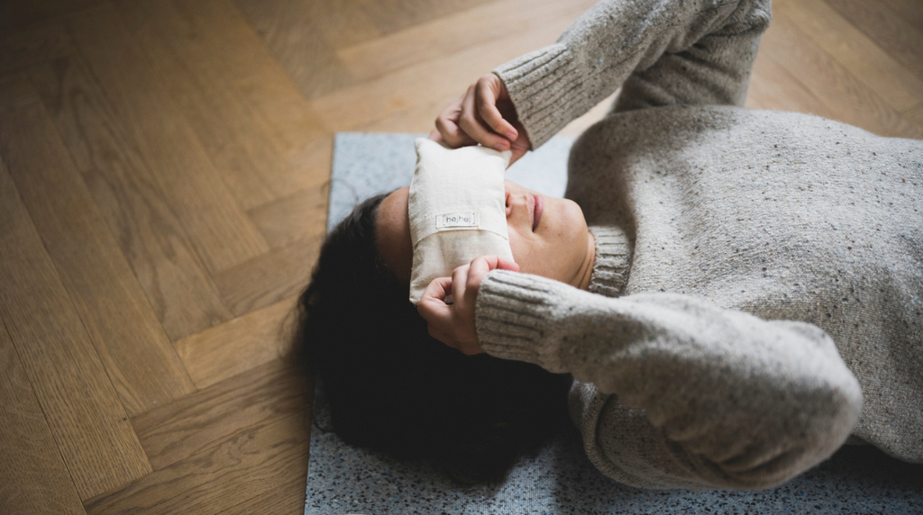 The eye pillow is placed gently on the eyes