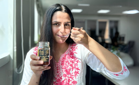 a women tasting honey and spice wild honey