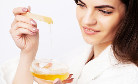 a girl using honey from honey and spice for benefits of honey on skin