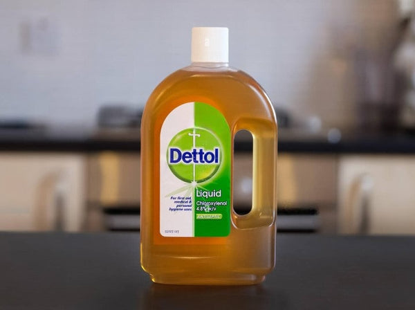 A bottle of dettol placed on a black table