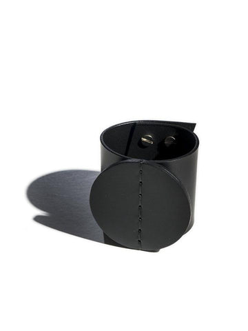 Black leather cuff set against white background.