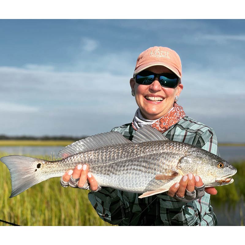 A beautiful redfish caught between rain showers this week with Captain Tuck Scott