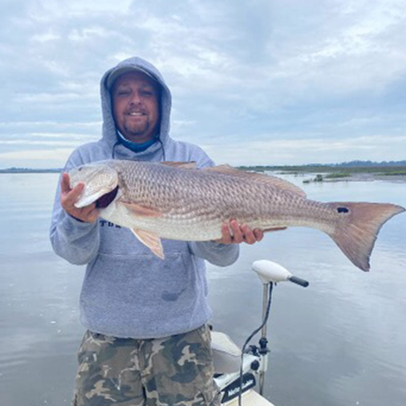 Captain Ron Davis, Jr. with a big Edisto redfish caught on the flats