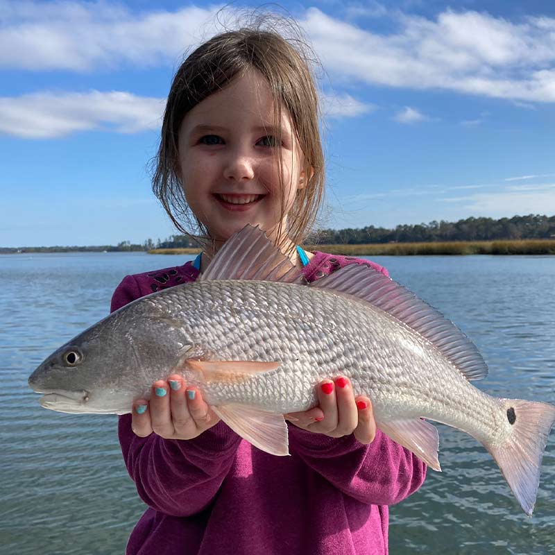 Captain Kai's daughter with a beautiful redfish