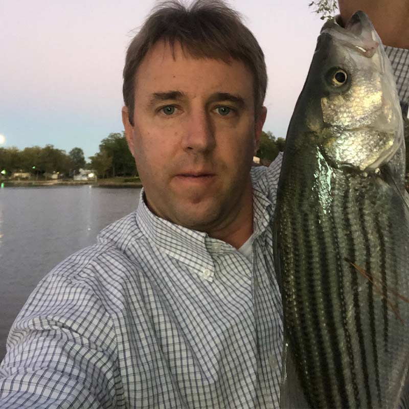 The author with an after-work striper caught in Beard's Creek