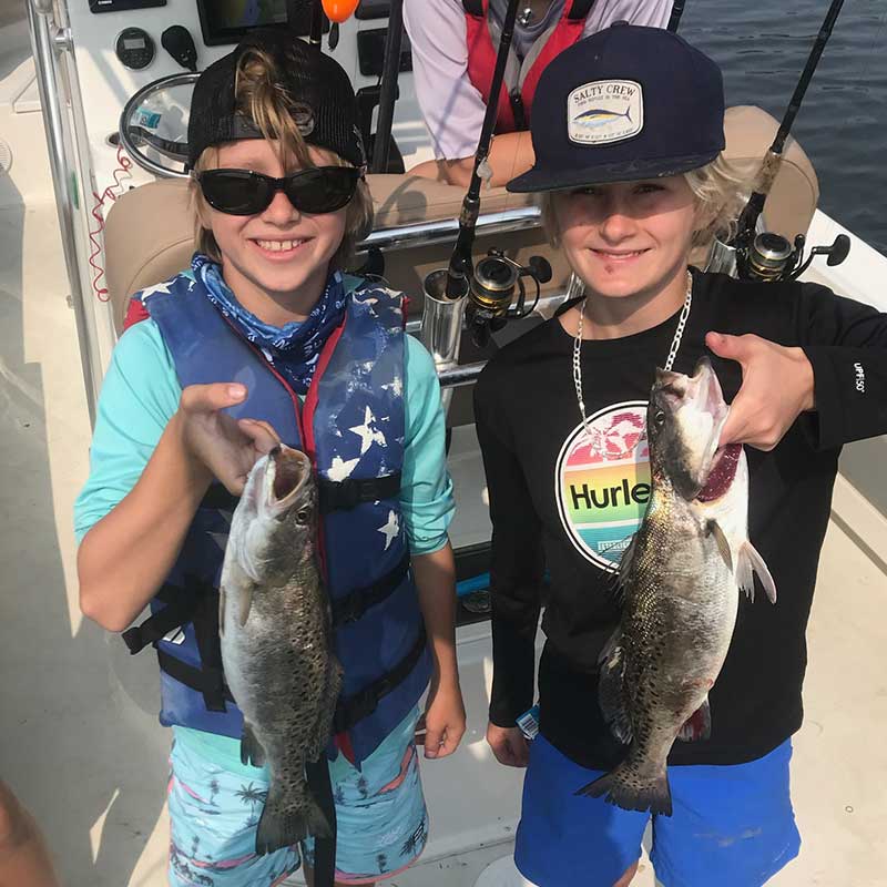 A couple of happy campers with Captain Smiley Fishing Charters